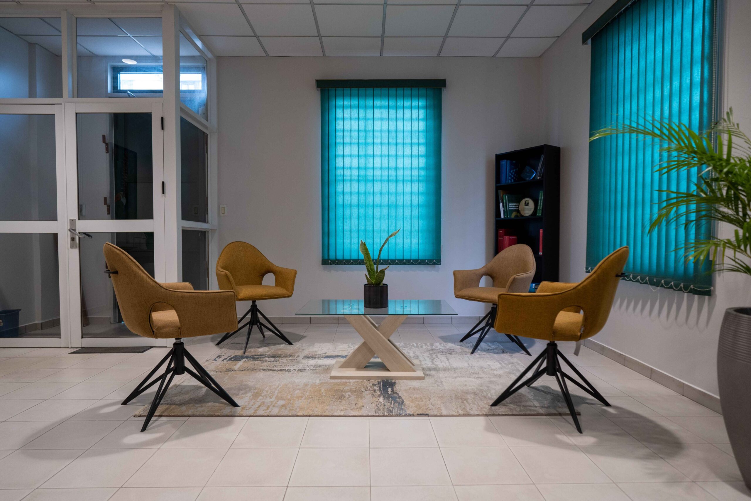 Virtual Office Suriname with modern office lounge area with four chairs around a glass table.